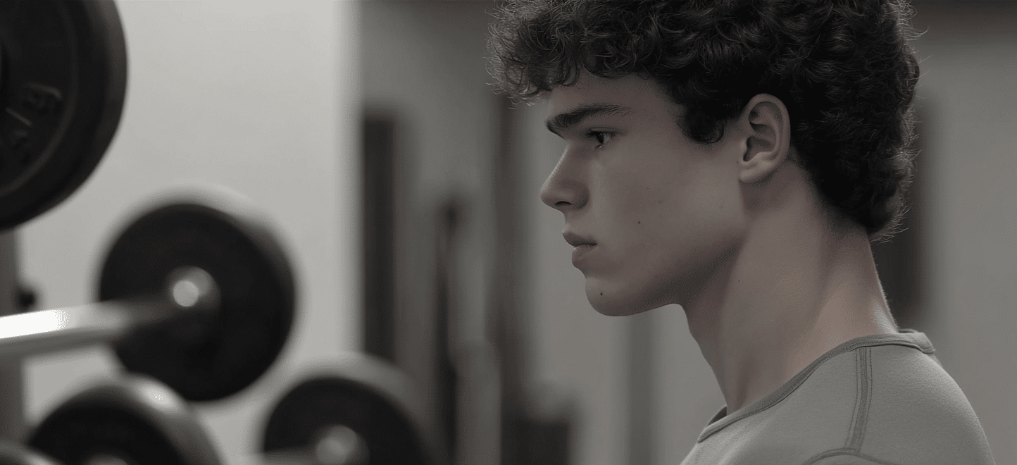 a young man at the gym wondering why he's dissatisfied with his body
