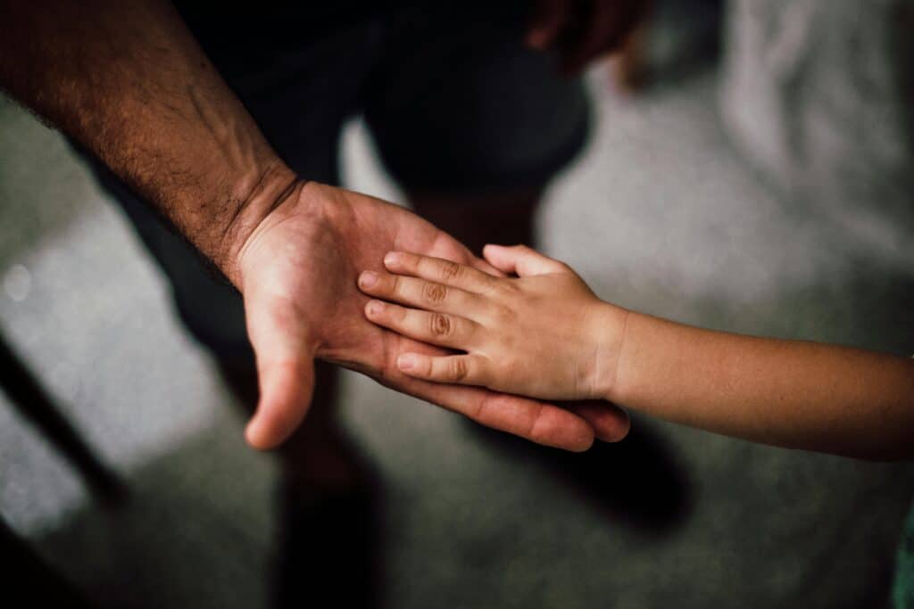 child hand in adult hand